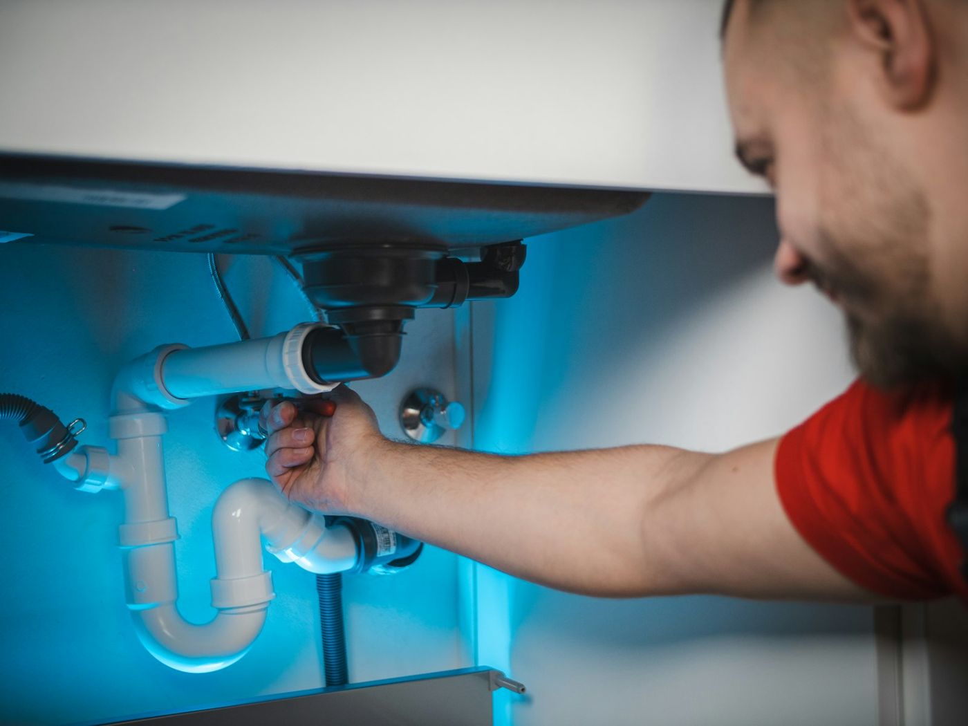 Tech replacing a kitchen sink trap