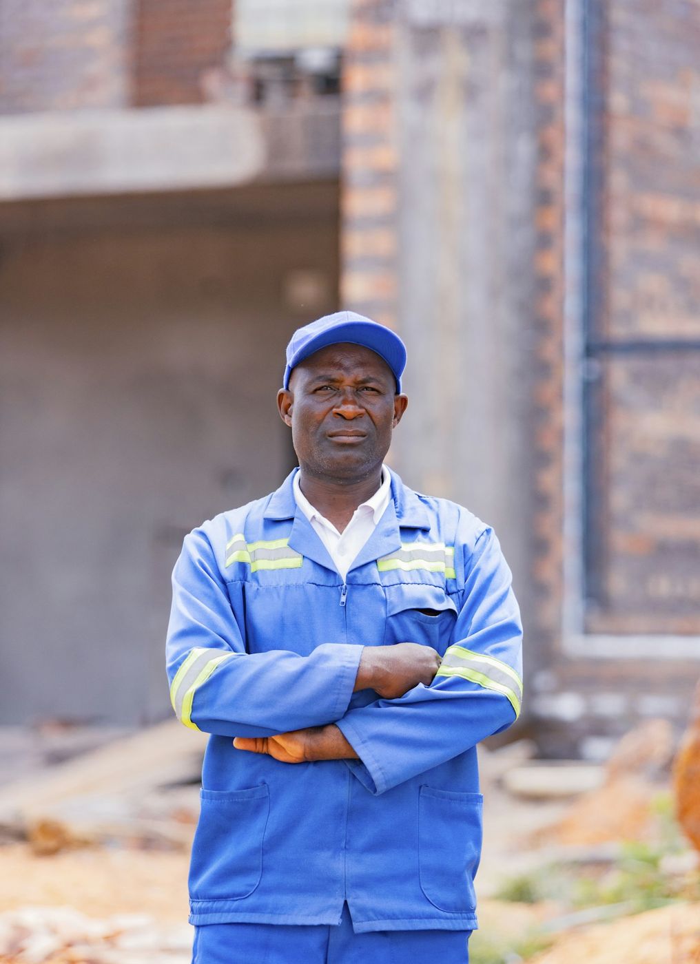 Ray Mercer, owner of Brightline, standing with arms crossed in his work coveralls