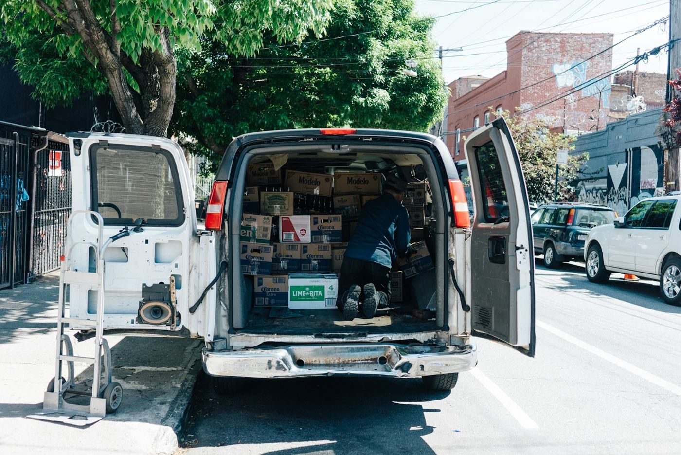 A tech loading parts into the back of a service van